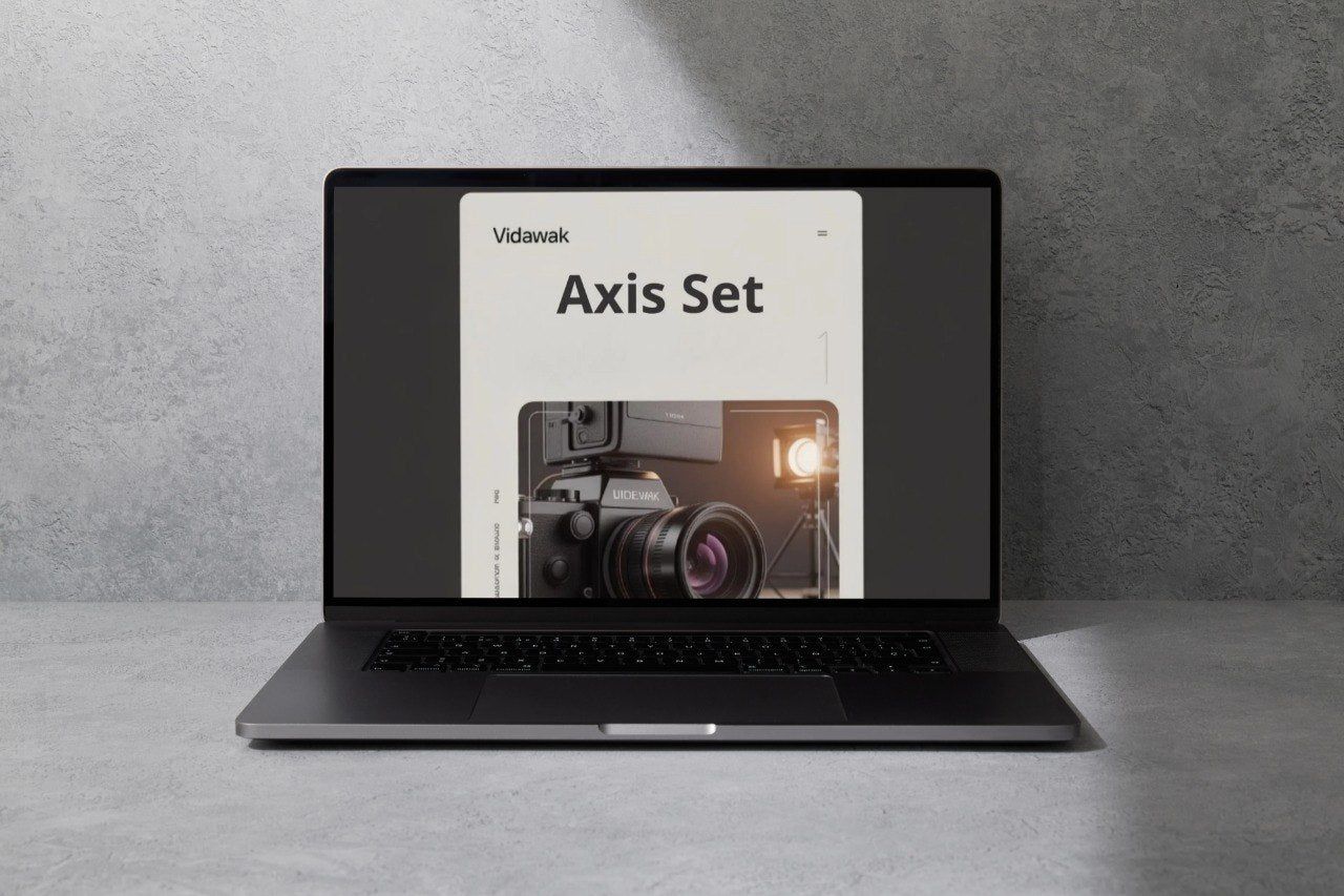 Laptop displaying a camera product on a gray surface with a gray background