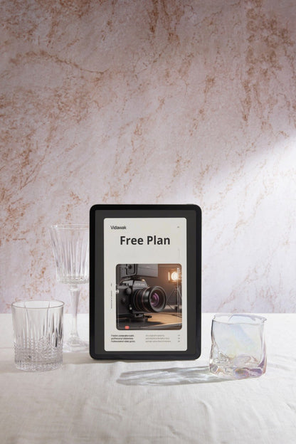 Digital display with 'Free Plan' on a marble surface with glasses and a knife.